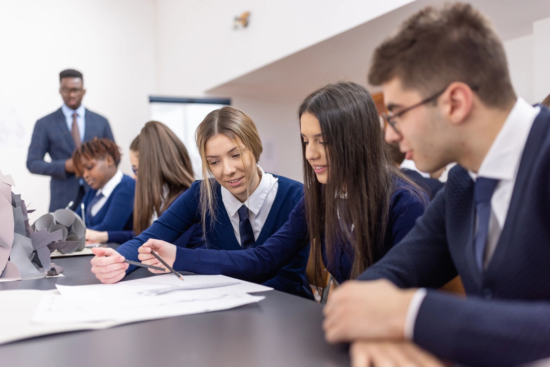 Students and teacher working together in an art class