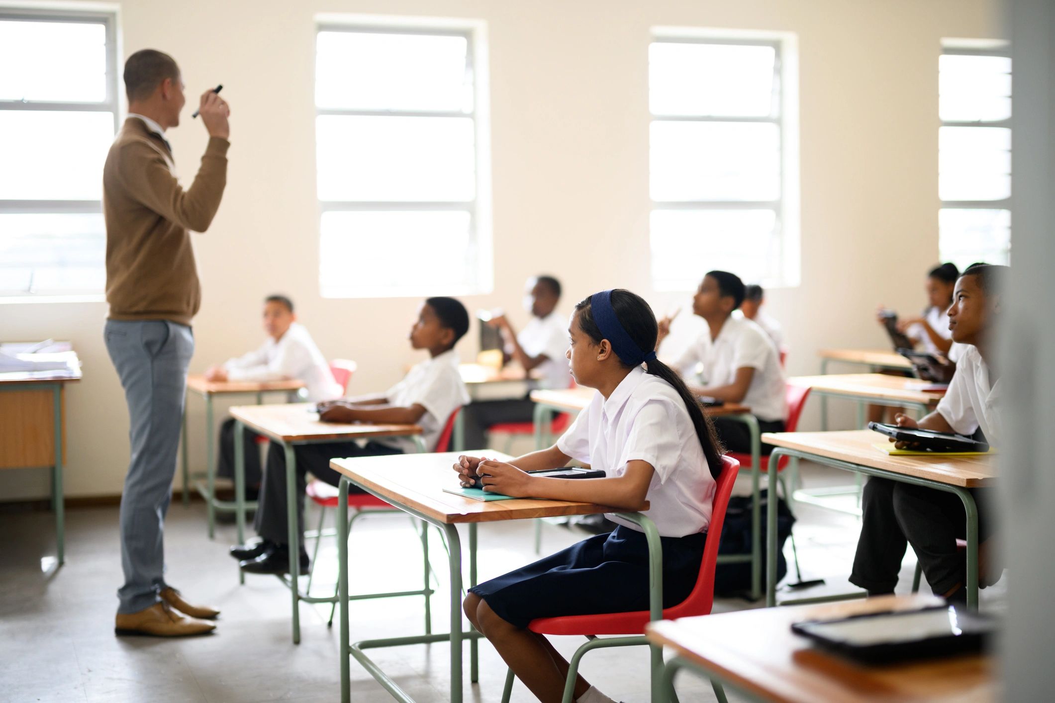 Student listening attentively at desk in class