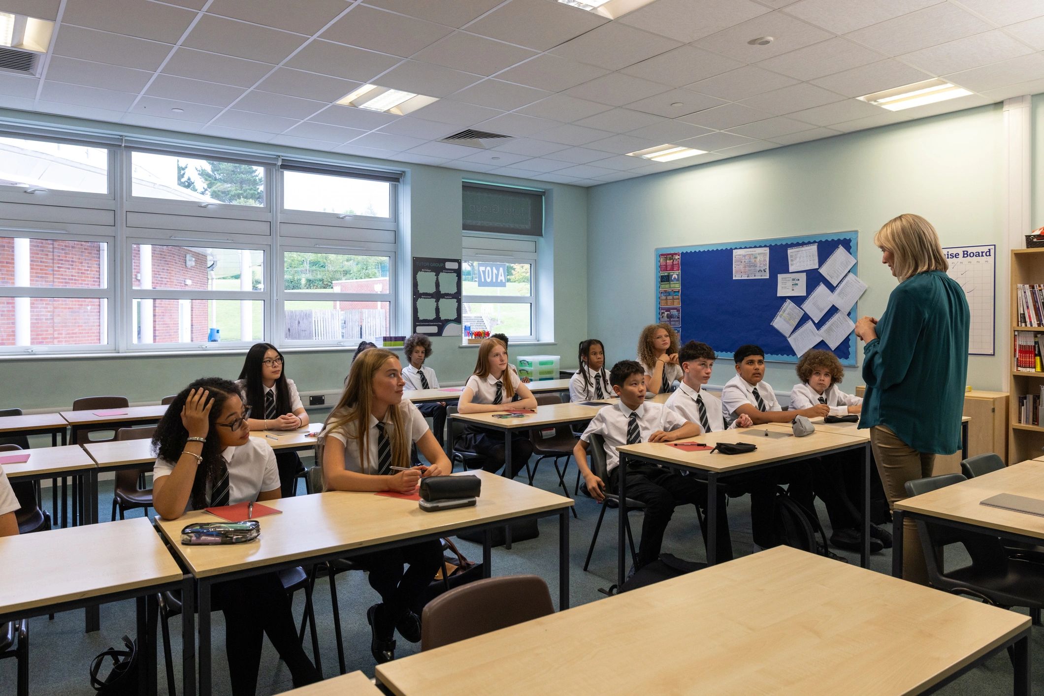 Teacher leading students in a bright modern classroom