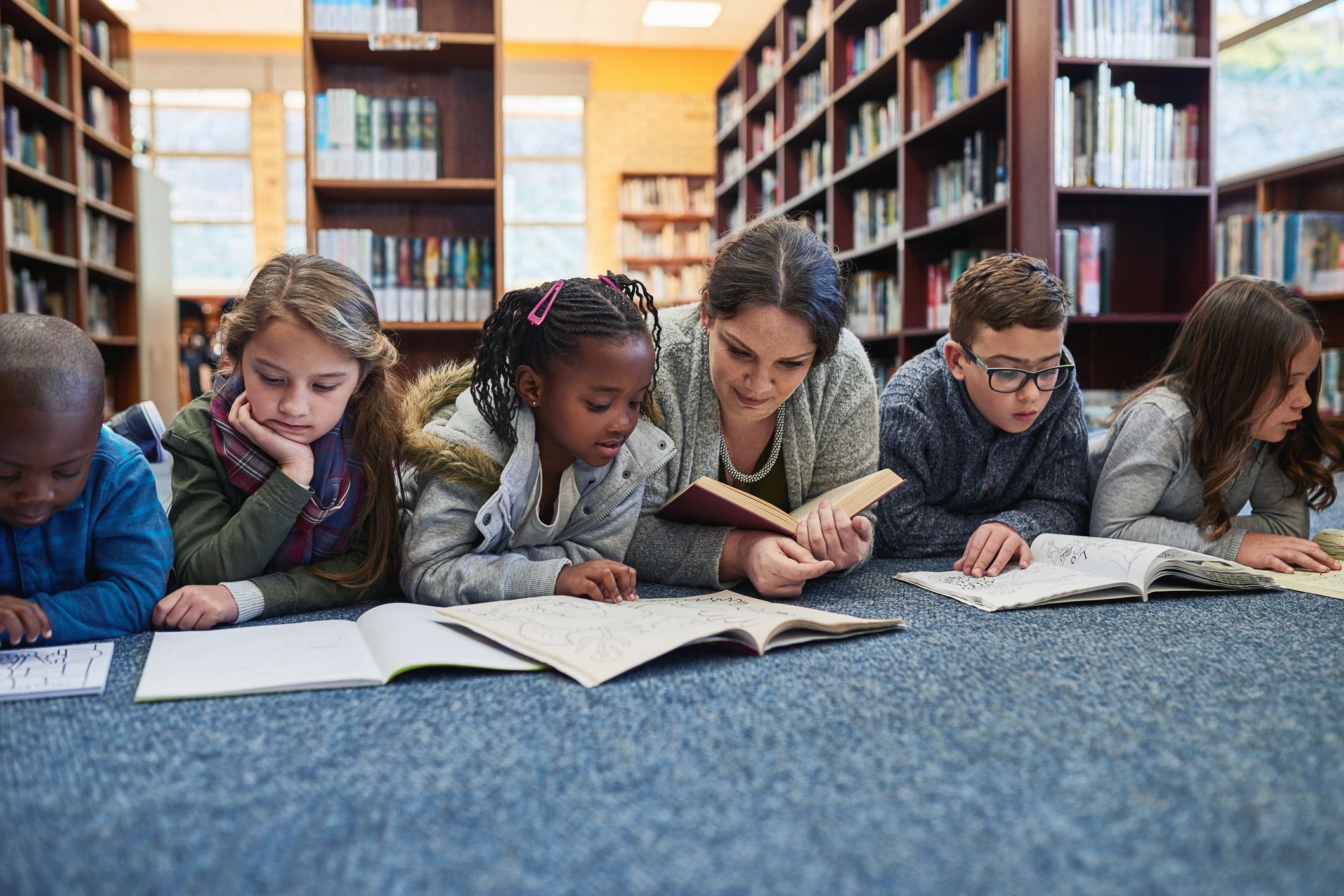 Elementary students and teacher learning together in the library